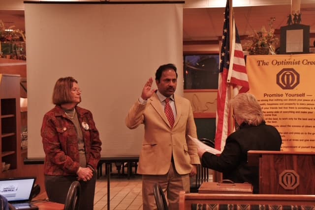 Dr. Vijay Kumar taking an oath of service with his local Optimist Club