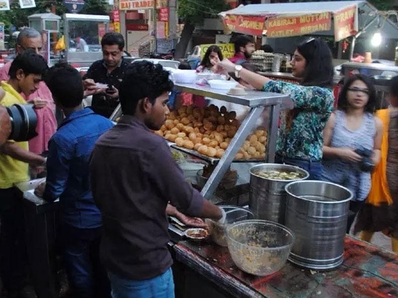 Street vendor preparing pani puri golgappa at an Indian food stall