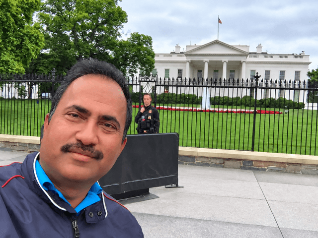 Vijay Kumar standing before the White House in Washington, D.C.